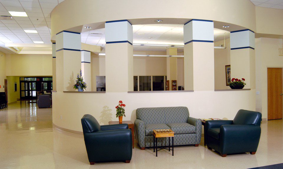 Senior Resource Center, Wisconsin Rapids, WI An inviting lobby scene with two chairs and a table, offering a cozy space for relaxation and social interaction